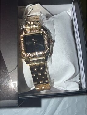 $249 WOMANS CELESTIAL WATCH GOLD BAND/BLACK FACE WITH CRYSTAL BEZEL